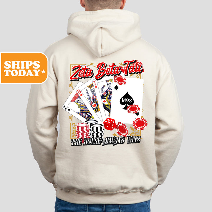 a man wearing a white hoodie with a card game on it