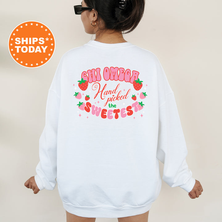 a woman wearing a white sweatshirt with a strawberry saying on it
