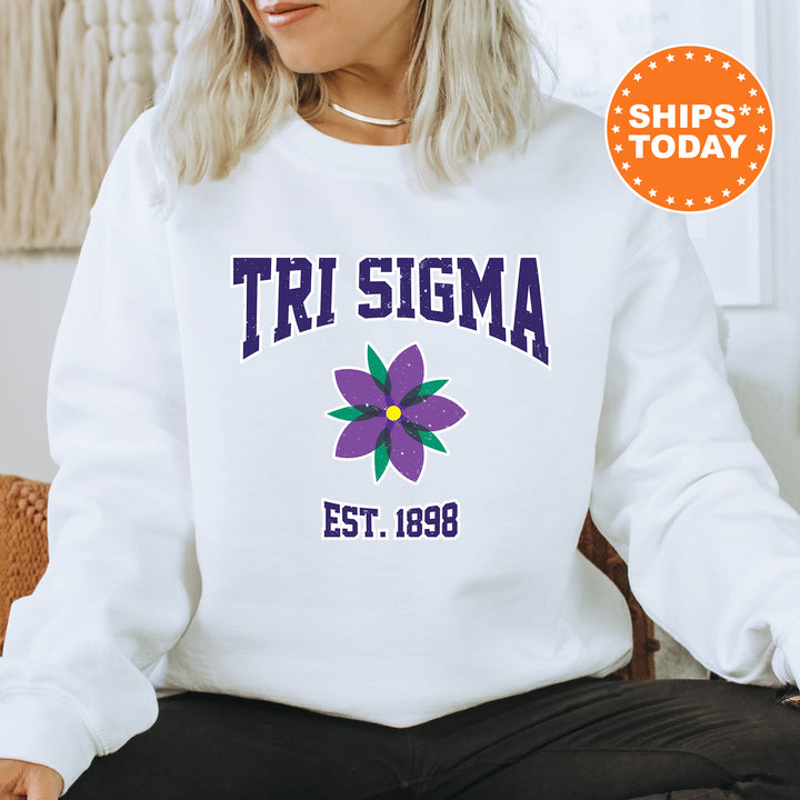 a woman sitting on a chair wearing a white sweatshirt