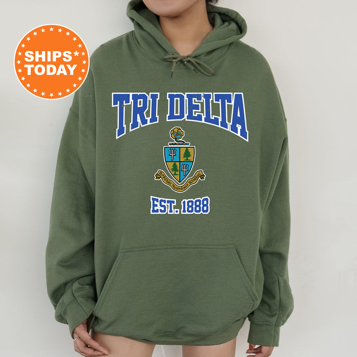a woman wearing a green hoodie with the words tri delta on it
