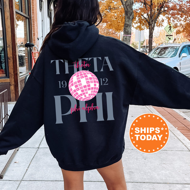 a woman in a black hoodie is walking down the street