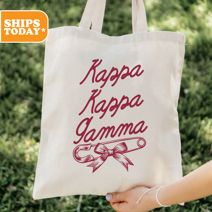 a person holding a tote bag with the words kappa kappa
