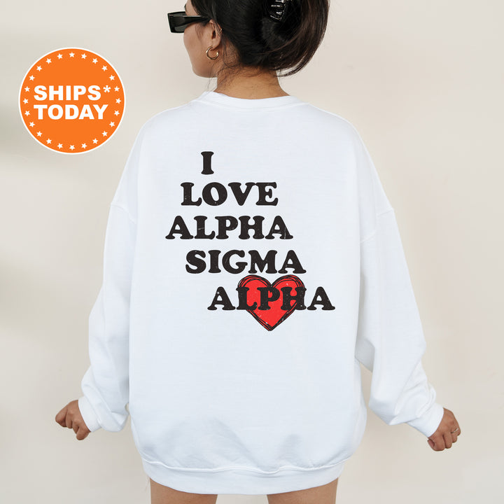 a woman wearing a white sweatshirt with the words i love alpha sigma