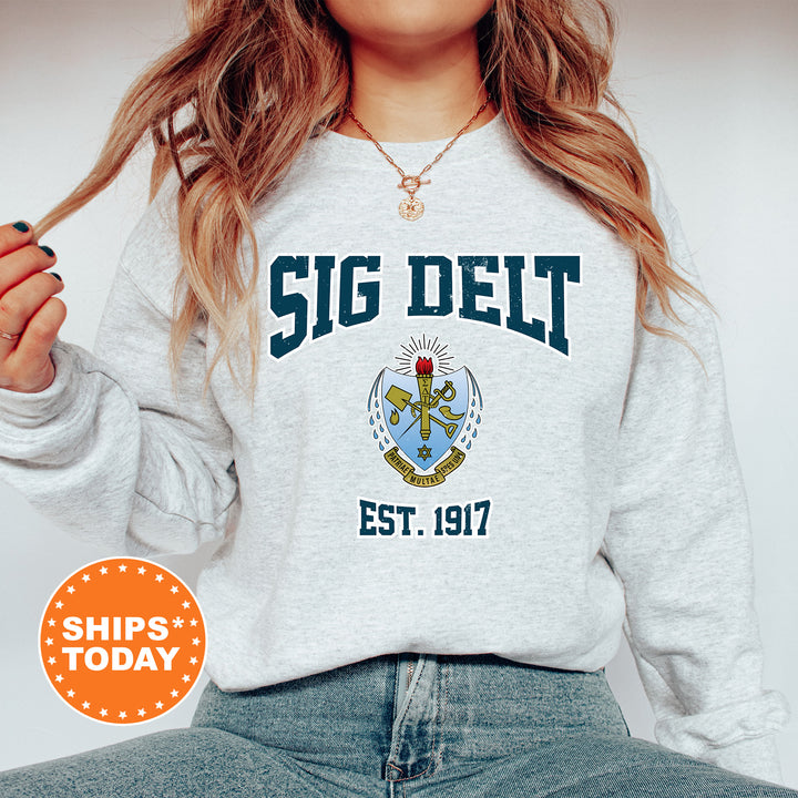 a woman with long hair wearing a sweatshirt and jeans