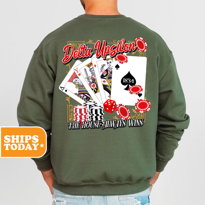 a man wearing a green sweatshirt with a picture of a deck of cards on it