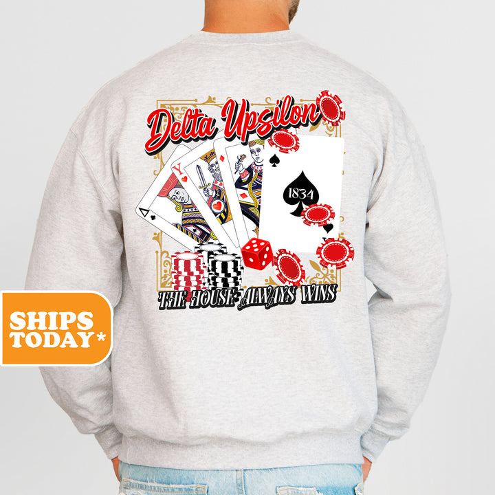 a man wearing a sweatshirt that has a picture of a deck of cards on it