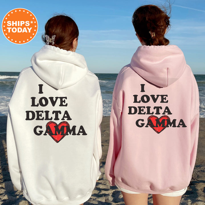 two women wearing matching sweatshirts on the beach