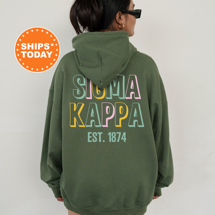 a woman wearing a green hoodie with the words summa kappa on