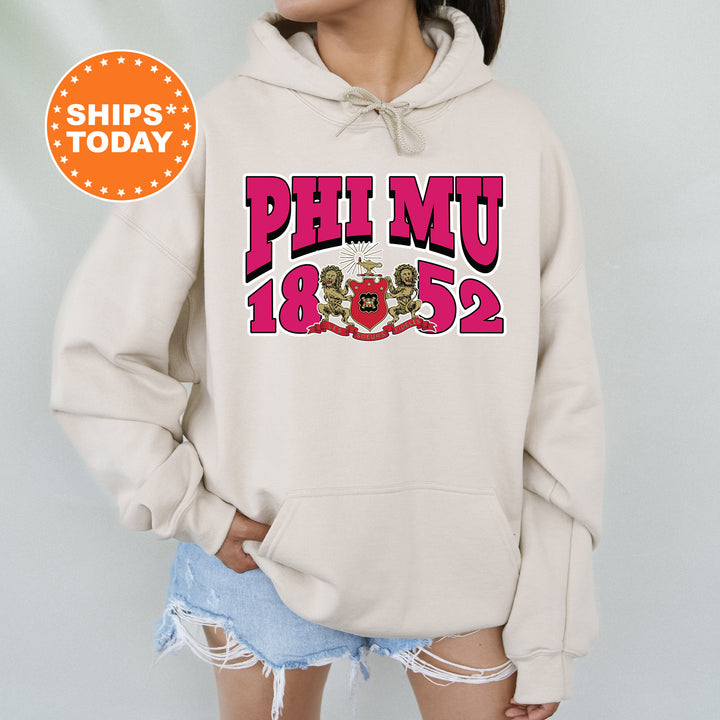 a woman wearing a phi mu hoodie and ripped shorts