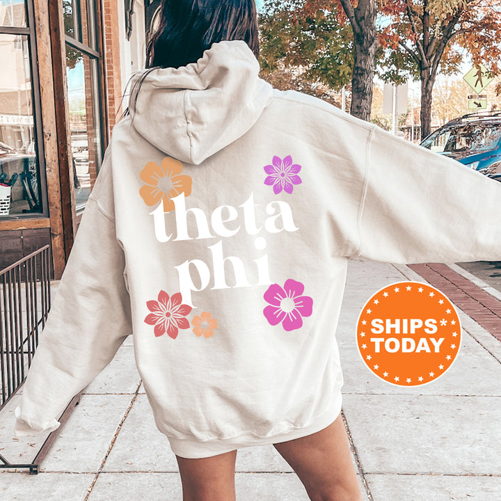 a woman walking down a sidewalk wearing a white hoodie