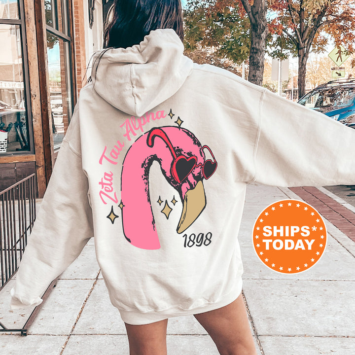 a woman walking down a sidewalk wearing a white hoodie