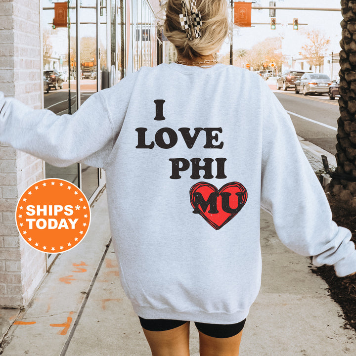 a woman walking down a sidewalk wearing a sweatshirt