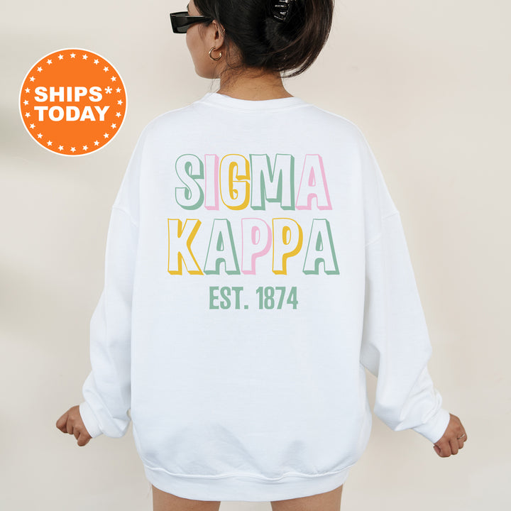 a woman wearing a white sweatshirt with the words soma kappa on it
