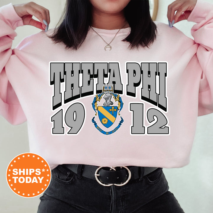 a woman wearing a pink sweatshirt with the phi phi symbol on it