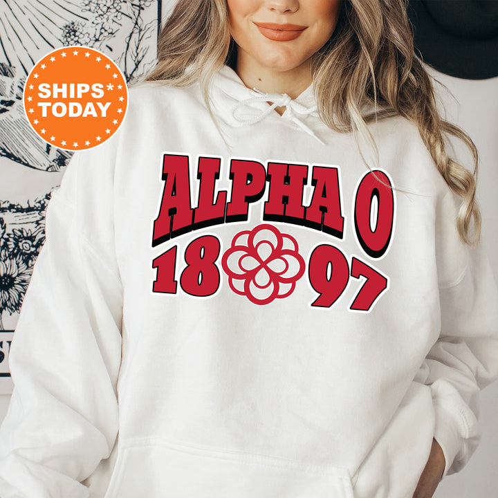 a woman wearing a white hoodie with a red and black graphic on it