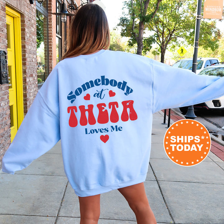 a woman walking down a sidewalk wearing a sweatshirt