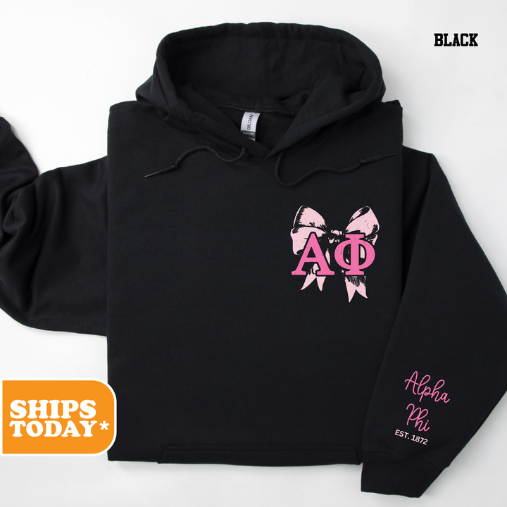 a black hoodie with pink bows on it