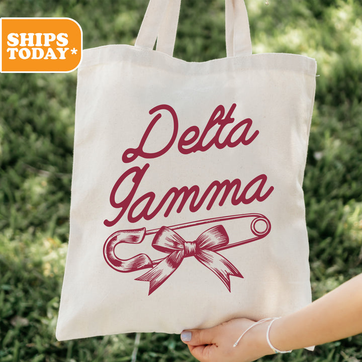 a person holding a tote bag that says delta garma