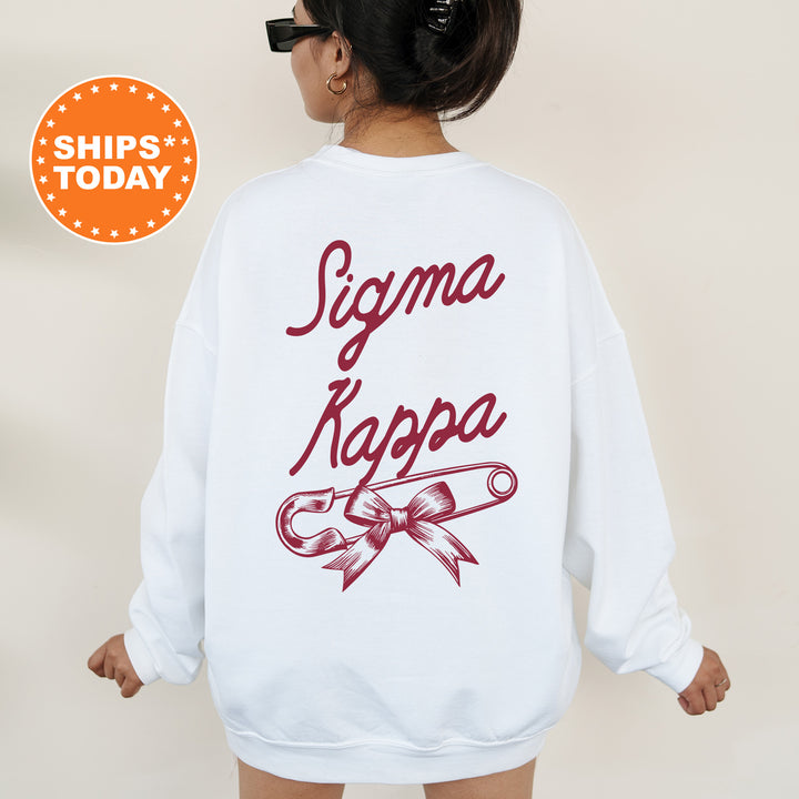 a woman wearing a white sweatshirt with the words stigma kapa on it