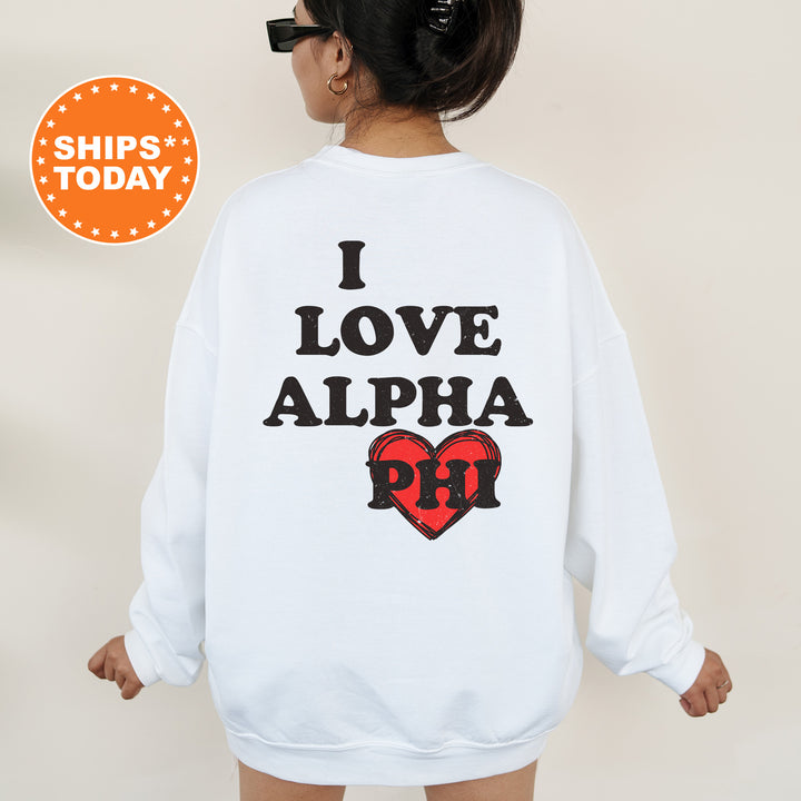 a woman wearing a white sweatshirt with the words i love alpha printed on it