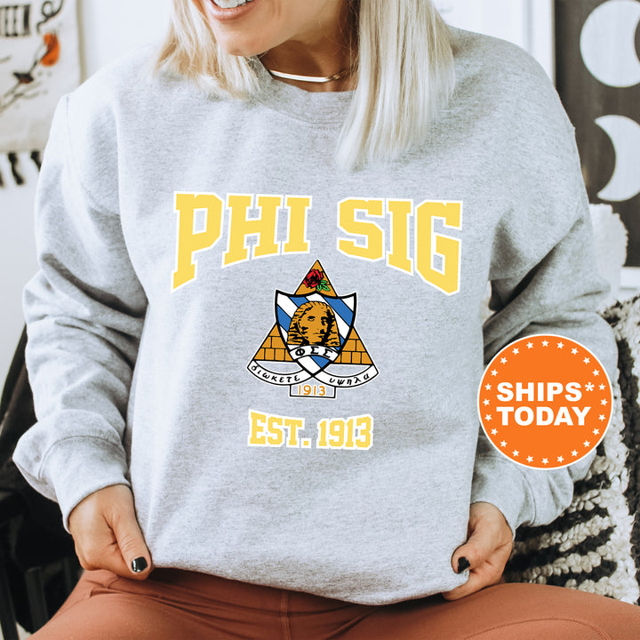 a woman sitting on a chair wearing a phi sig sweatshirt