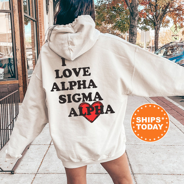 a woman walking down a sidewalk wearing a white hoodie