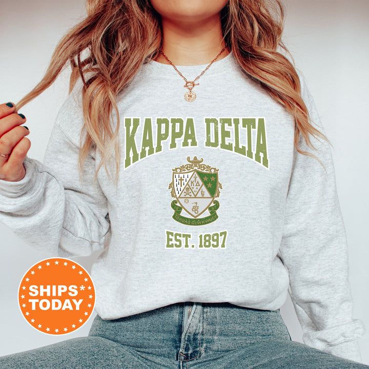 a woman wearing a sweatshirt that says kapa delta est 1897
