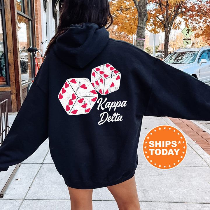 a woman in a black hoodie is walking down the street