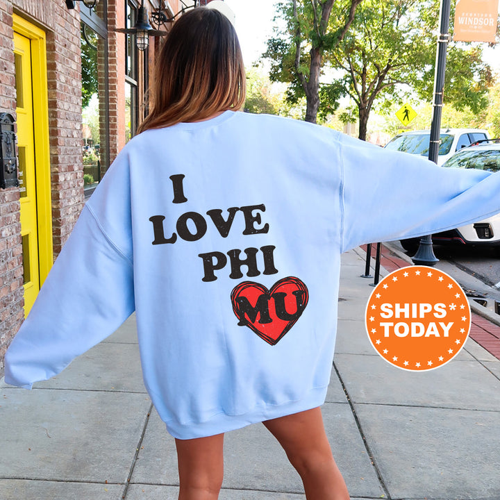a woman walking down a sidewalk wearing a blue sweatshirt
