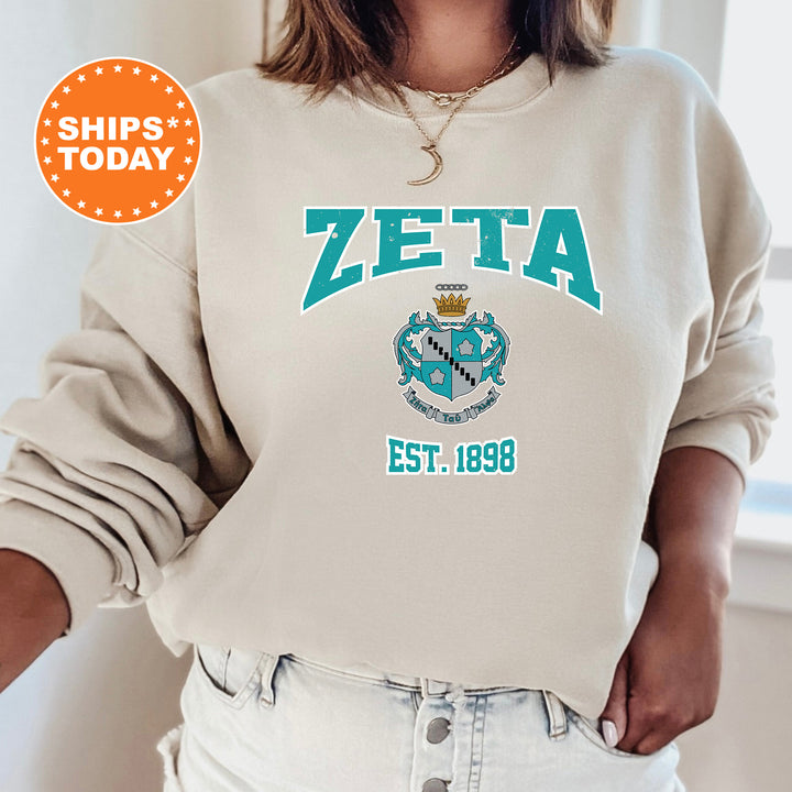 a woman wearing a zeta sweatshirt and jeans