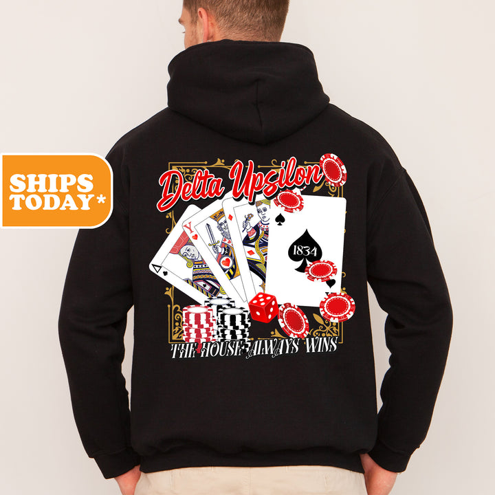 a man wearing a black hoodie with a picture of playing cards on it