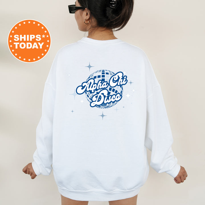 A person wearing a white sweatshirt with a graphic design on the back, featuring a blue and white disco ball and the text "Alpha Chi Dices" in a stylized font.