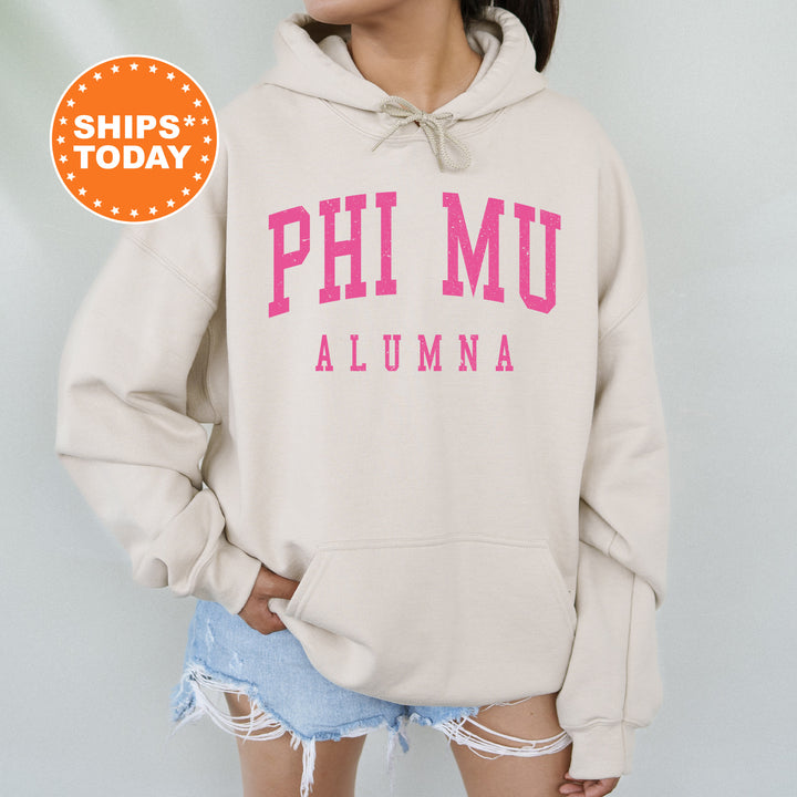 a woman wearing a sweatshirt with the words phi mu on it