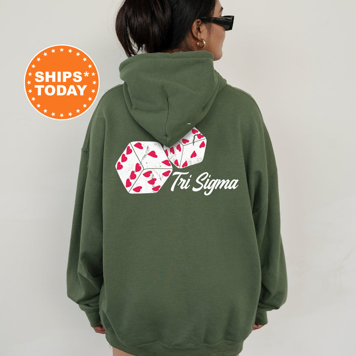 a woman wearing a green hoodie with a pair of playing cards on it