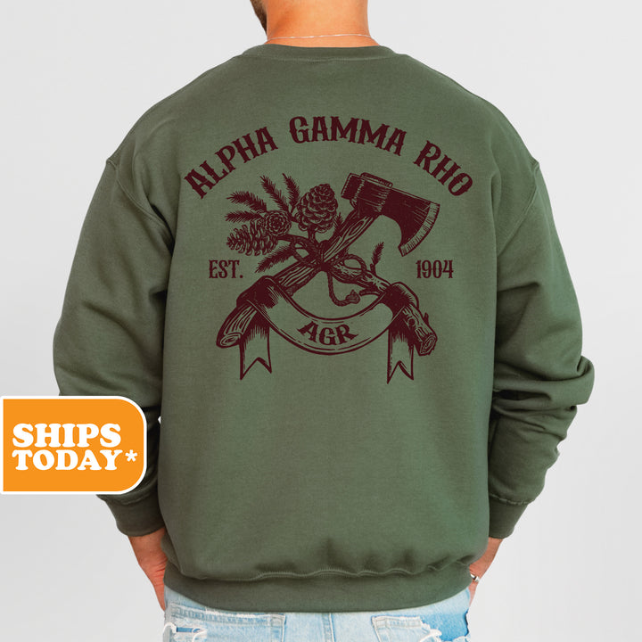 a man wearing a green sweatshirt with a hammer and pine cones on it