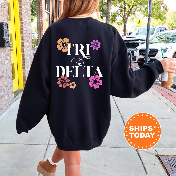 a woman walking down a sidewalk wearing a sweatshirt