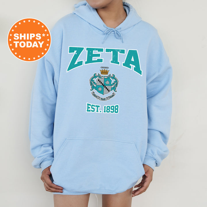 a person wearing a blue hoodie with the word zeta on it