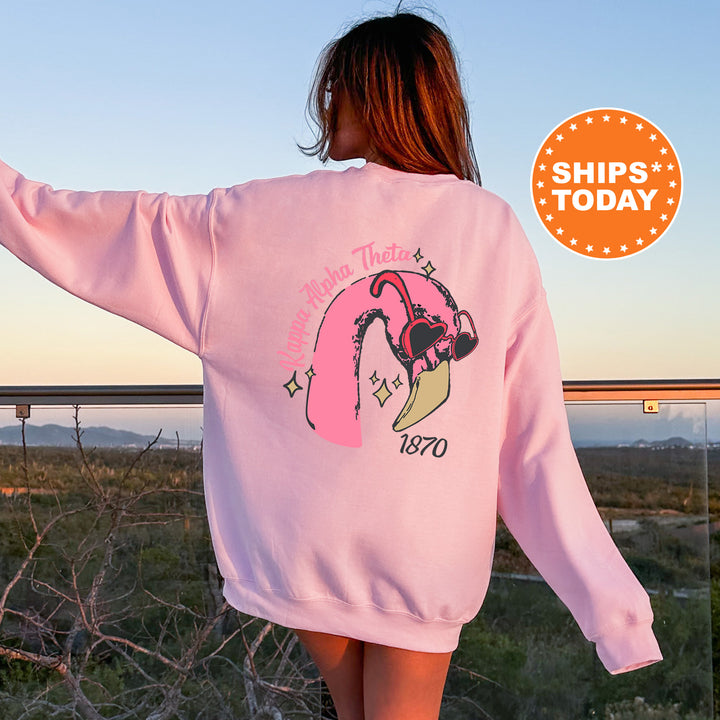 a woman wearing a pink sweatshirt with a picture of a girl on it