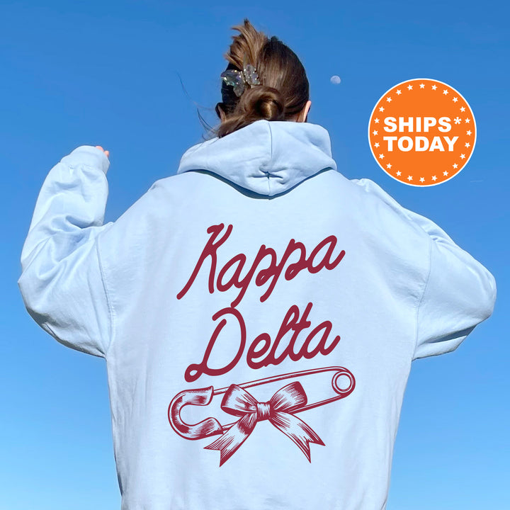 a woman with her back to the camera wearing a white hoodie with the words