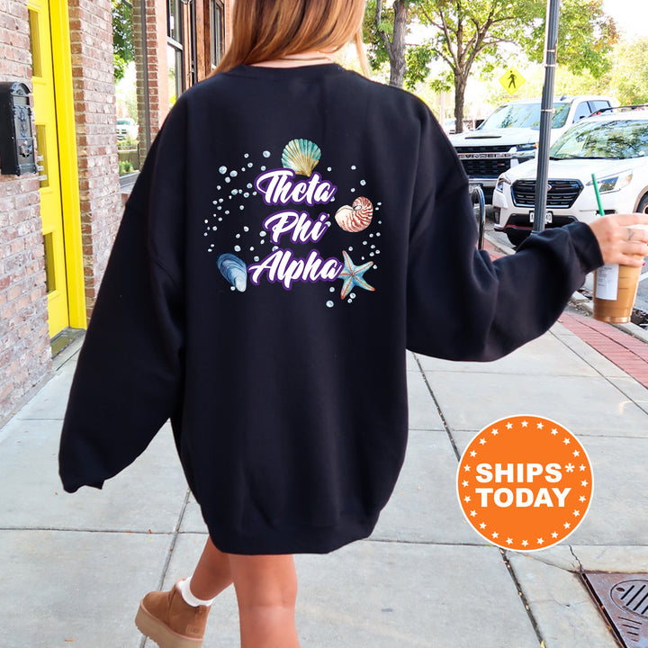 a woman walking down a sidewalk wearing a black sweatshirt