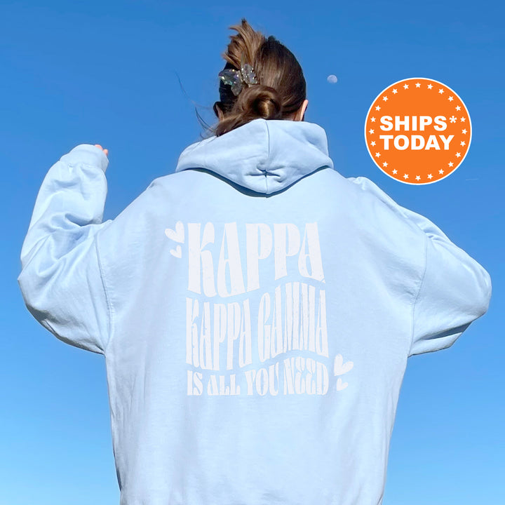 a woman in a white hoodie with a blue sky in the background