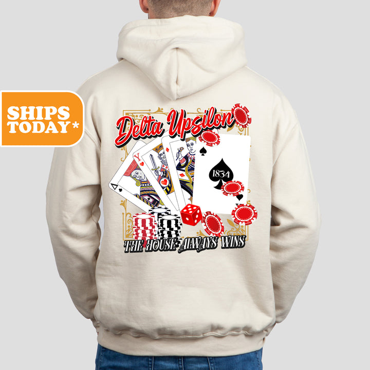 a man wearing a white hoodie with a back print of a deck of cards