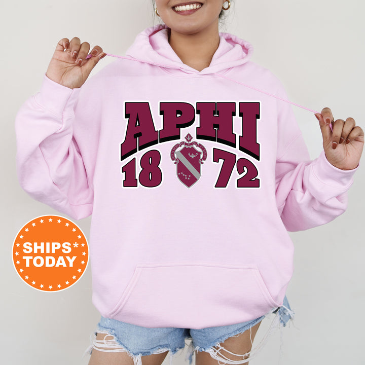 a woman wearing a pink hoodie with the words april on it