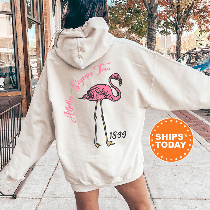 a woman in a white sweatshirt with a pink flamingo on it