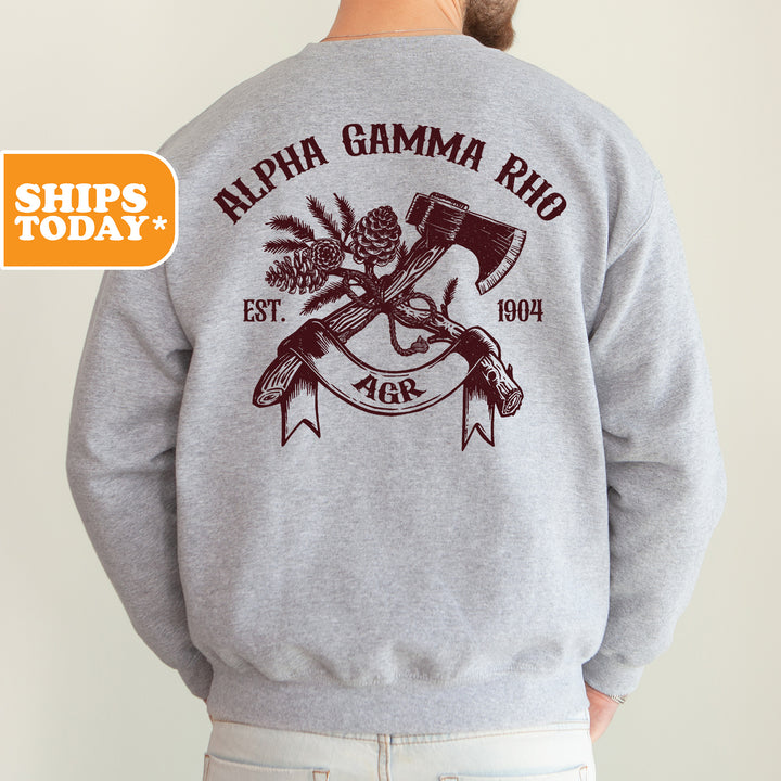 the back of a man wearing a sweatshirt with an image of a hammer and pine