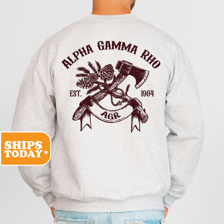 a man wearing a sweatshirt with an image of a gun and a pine cone on