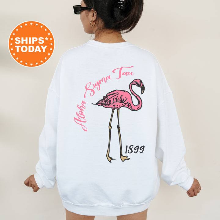 a woman wearing a white sweatshirt with a pink flamingo on it