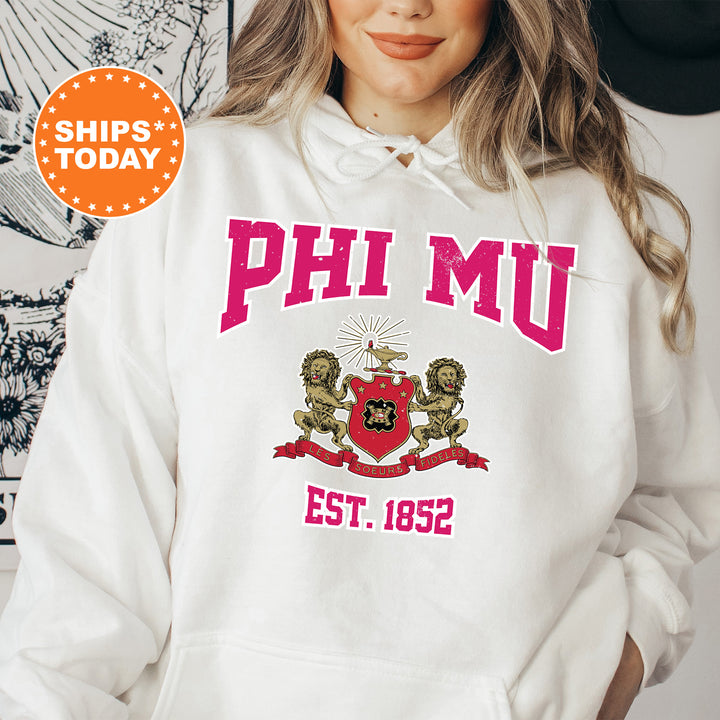 a woman wearing a white phi mu hoodie