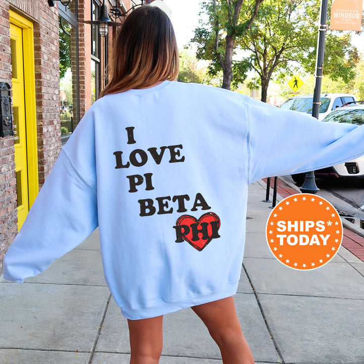 a woman walking down a sidewalk wearing a blue sweatshirt