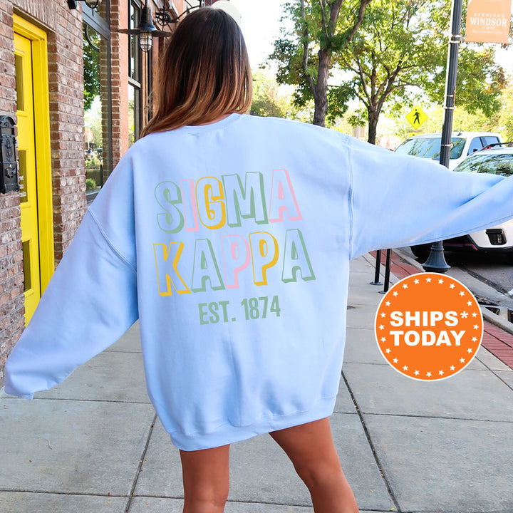 a woman walking down a sidewalk wearing a blue sweatshirt
